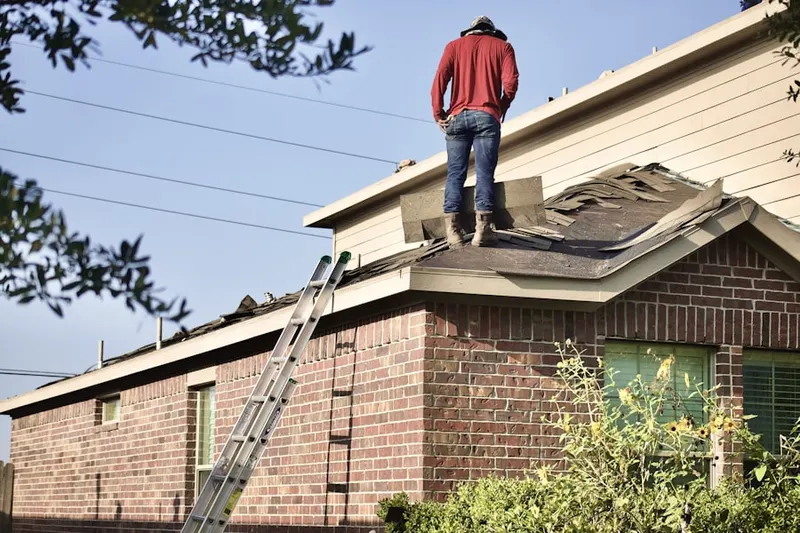 Professional roofer working on a residential roof in Charles Town